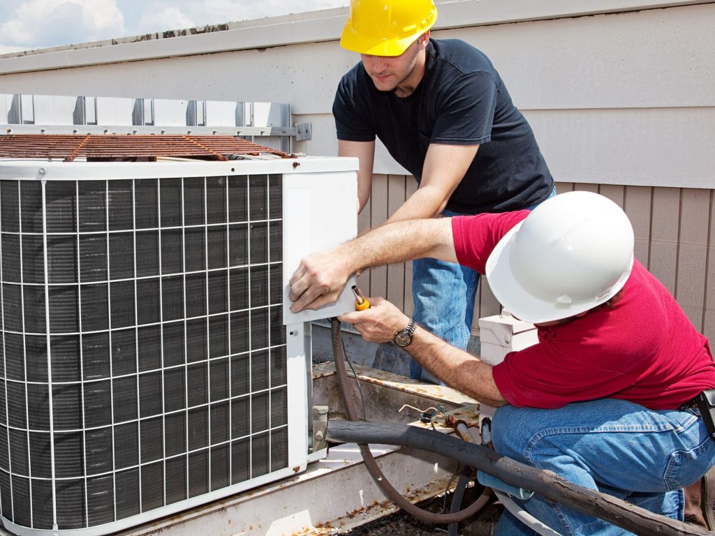 Expert technicians cleaning ducts.